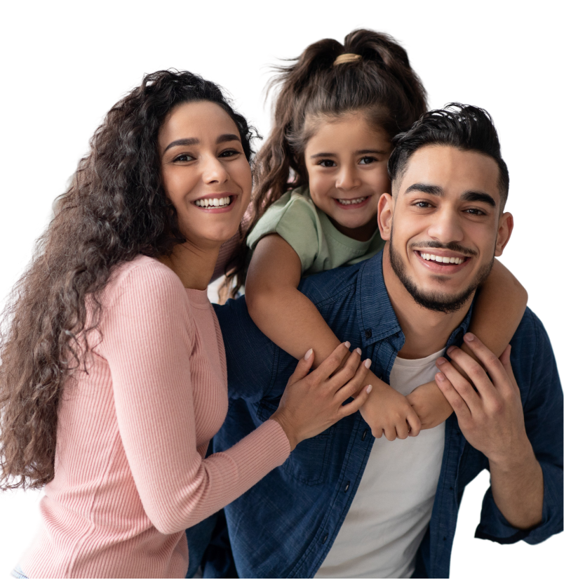 Happy family with young girl smiling and embracing each other outdoors.