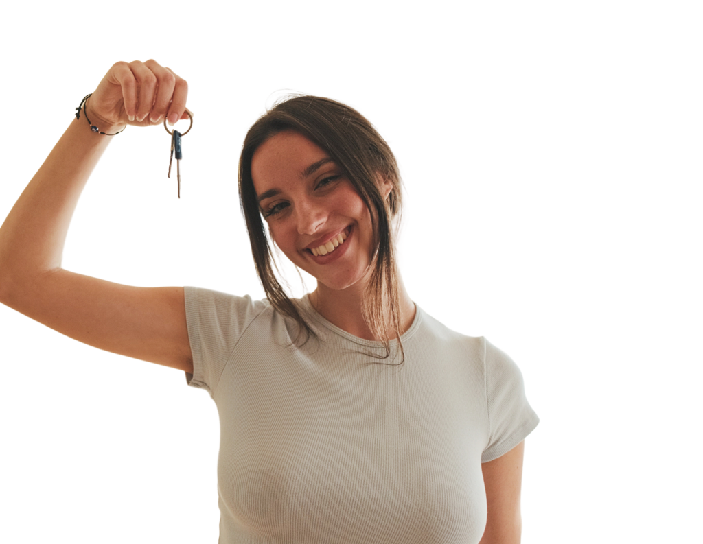 Happy woman holding up a key, symbolizing success and achievement.