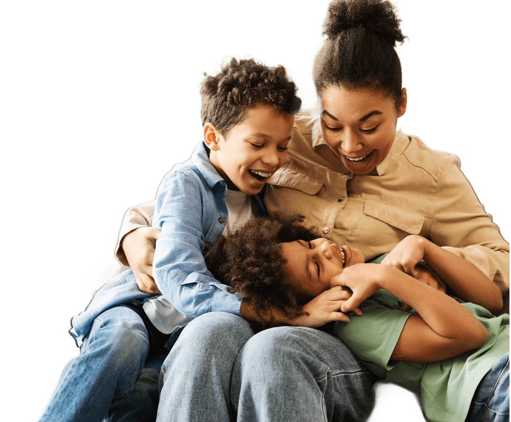 Happy family playing and laughing together outdoors in a joyful moment.