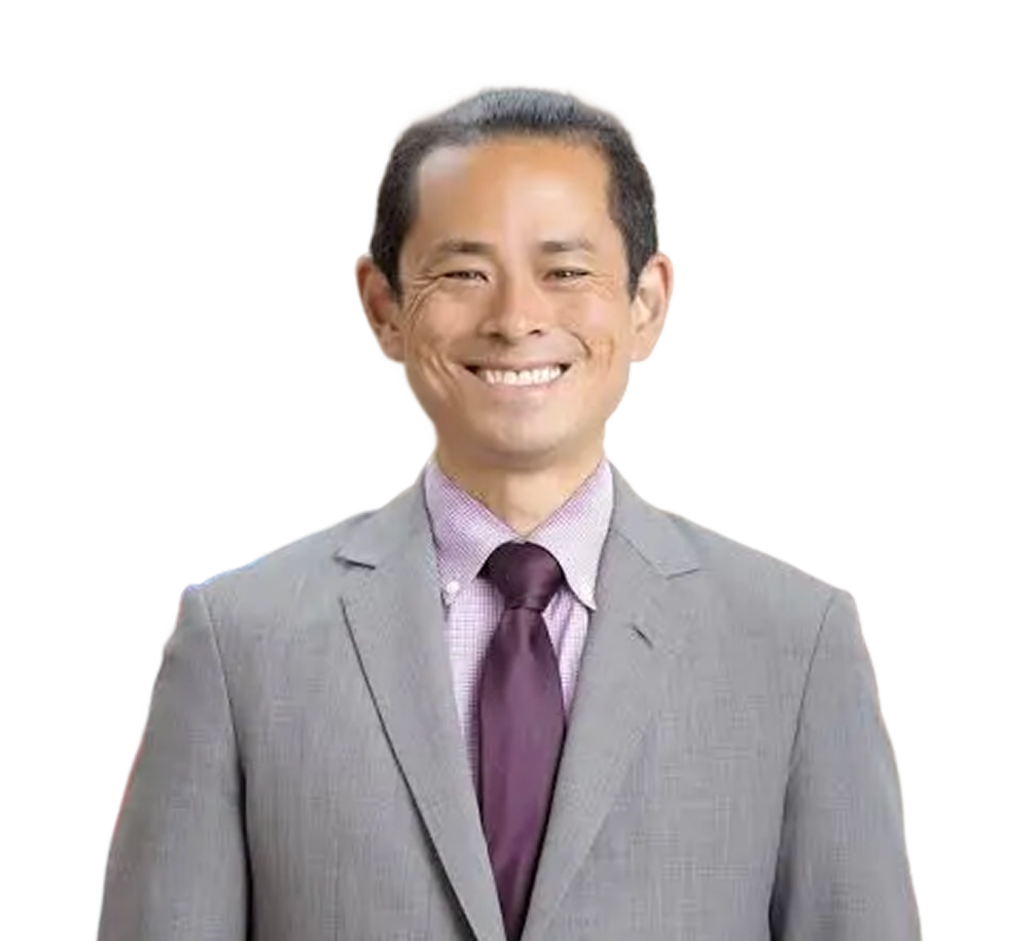 Smiling professional man in gray suit and purple tie at Prosperity Now event.